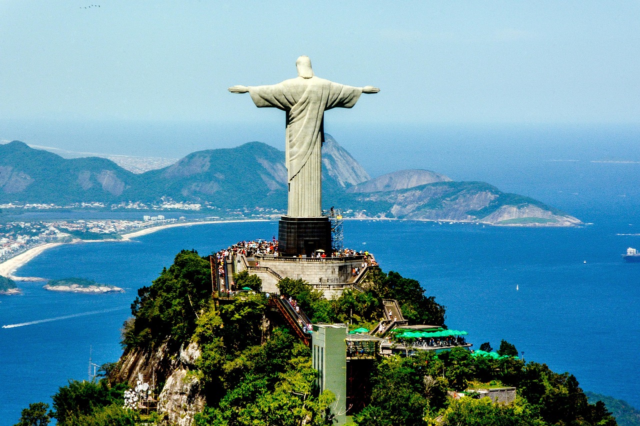 Captivating view of Sugarloaf Mountain in Rio de Janeiro with boats in the bay under a clear sky.