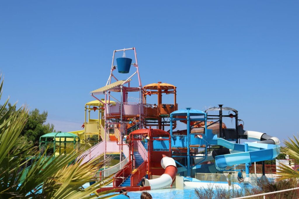 pexels-photo-19814297-19814297 Colorful waterslides at an outdoor aquapark on a sunny summer day.